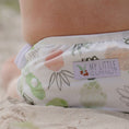 Load image into Gallery viewer, Reusable Swim Nappy - Pineapples design on a child at the beach, showcasing sustainable swimwear from My Little Gumnut.