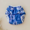 Load image into Gallery viewer, Reusable Swim Nappy in blue with playful patterns and buttons, perfect for swim lessons and beach fun.