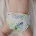 Load image into Gallery viewer, Reusable Swim Nappy featuring Tropical Gardens design on a baby, perfect for beach and pool activities.