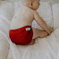 Load image into Gallery viewer, Baby wearing a Reusable Cloth Nappy – Terracotta | 2.0 | My Little Gumnut with a secure fit and soft bamboo lining.