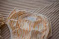 Load image into Gallery viewer, Reusable Swim Nappy Sandy Blaze with a stylish orange wave pattern for beach days and pool play.