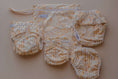 Load image into Gallery viewer, Reusable Swim Nappy set featuring multiple sizes and a storage pouch in Sandy Blaze design by My Little Gumnut.