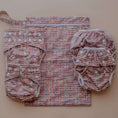 Load image into Gallery viewer, Plaid reusable wet bag displayed with cloth nappy essentials and accessories