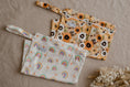 Load image into Gallery viewer, Pastel Medley reusable wet bag displayed with matching baby accessories and essentials 💚