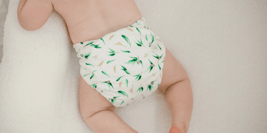 Baby lying on belly with My Little Gumnut Nappy 2.0