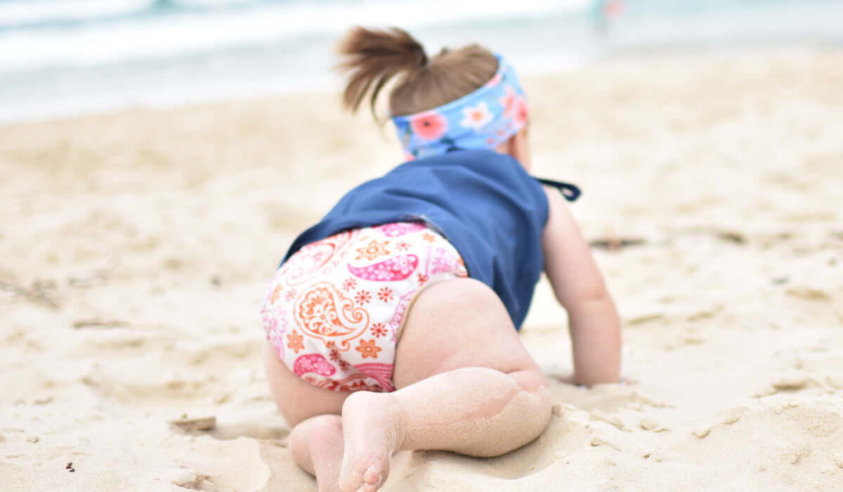 Baby girl on the beach in a My Little Gumnut Swim Nappy