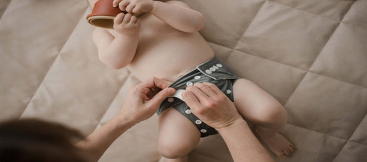 Mum changing a My Little Gumnut Cloth Nappy on a baby