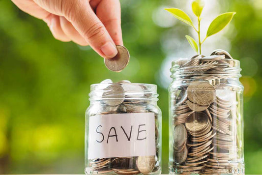 Putting coins in a jar saving money