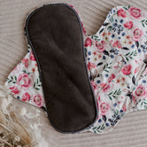 Reusable menstrual pads by my little gumnut. cloth menstrual pads. period pads. stack of menstrual pads. floral pads