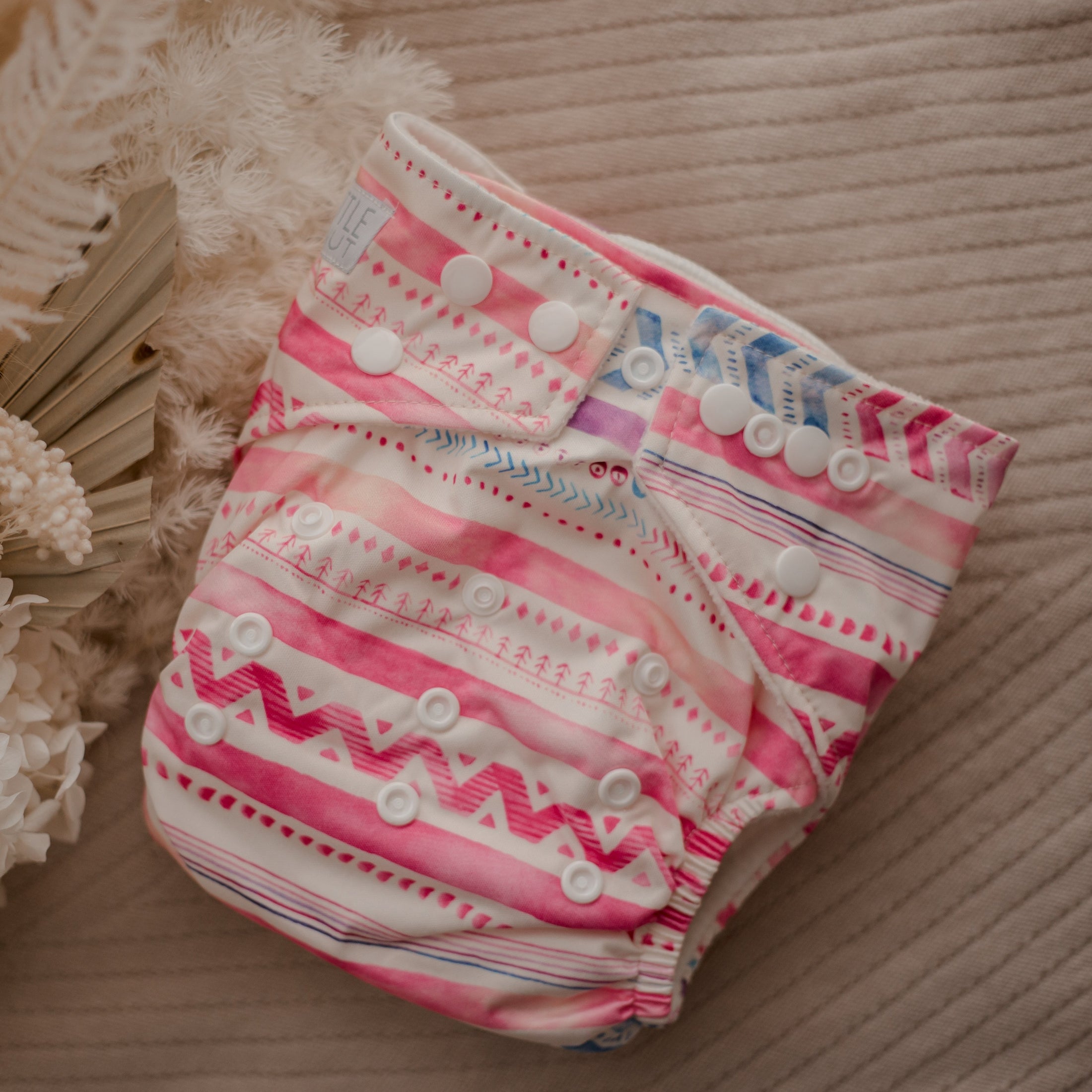 Reusable cloth nappy. Reusable diapers. Cloth nappy by My Little Gumnut in Aztec Pink design. Australian cloth nappies. 