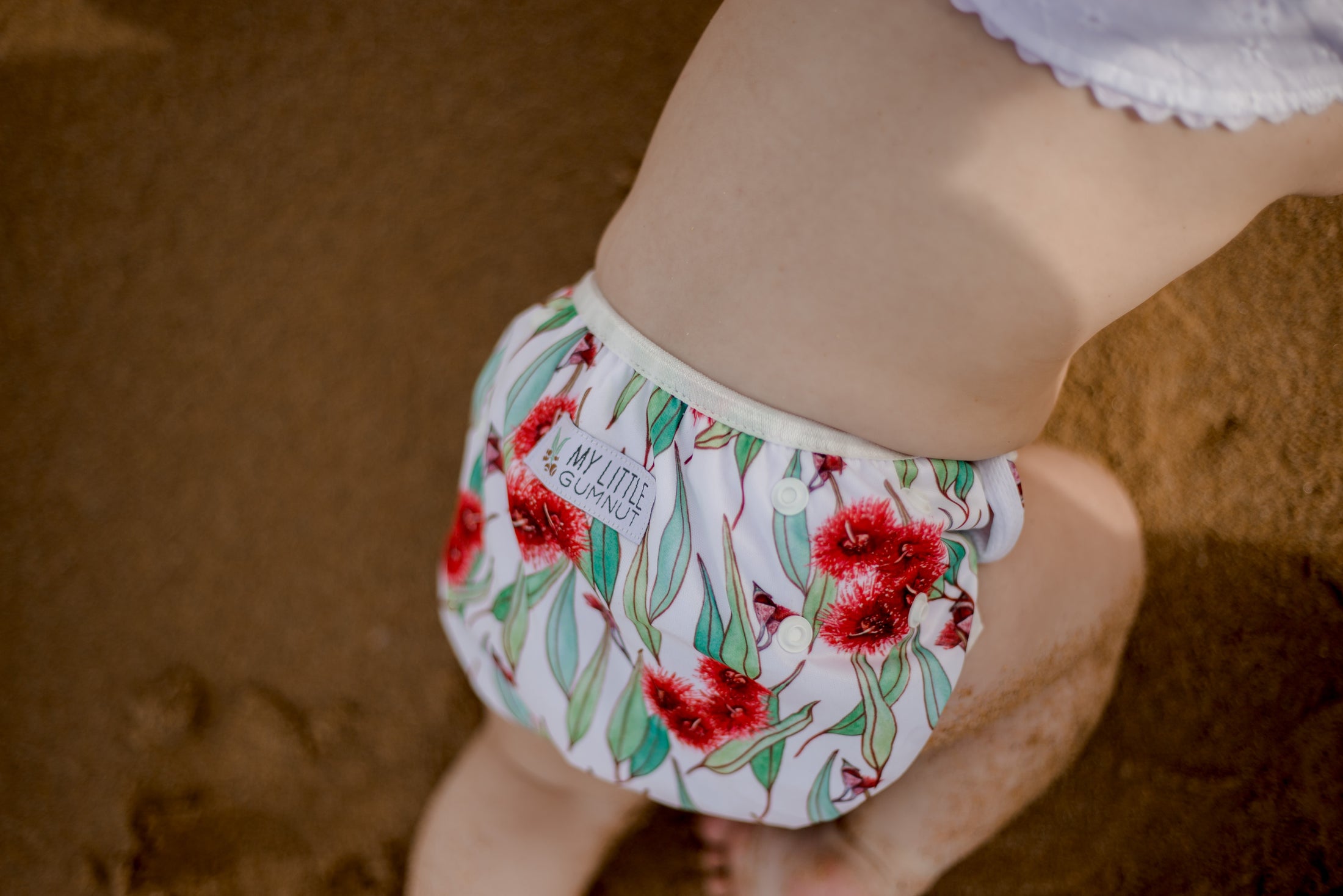 beach baby wearing Flowering gum Australiana swim nappy. Reusable swimming nappy. My little gumnut. 